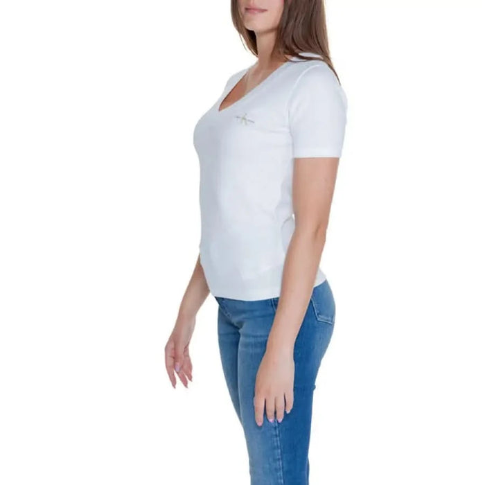 Stylish woman wearing Calvin Klein white t-shirt and blue jeans - Calvin Klein Jeans collection