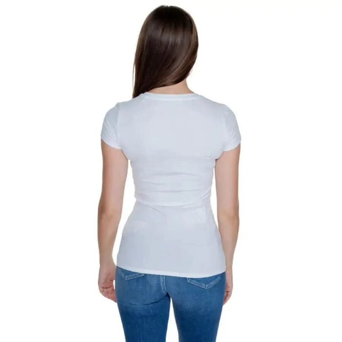 Woman in white Guess T-Shirt and blue jeans, rear view, product display