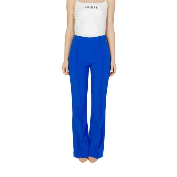 Woman in white tank top and blue women trousers for urban style clothing