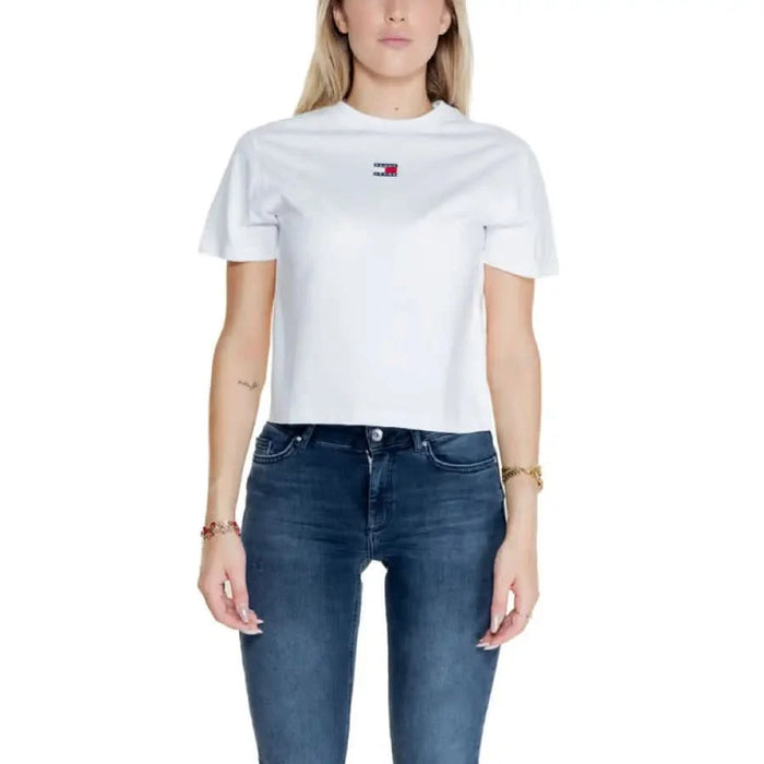 Woman in white Tommy Hilfiger crop top and blue jeans from Tommy Hilfiger Women T-Shirt collection