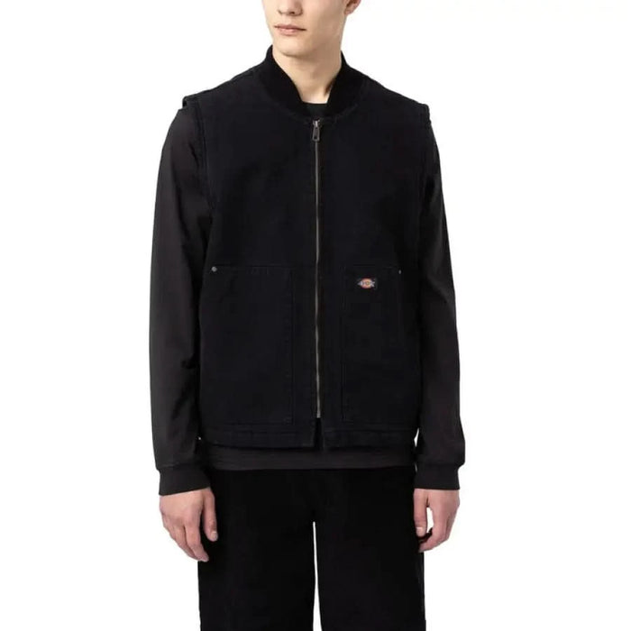 Young boy models Dickies Men Gilet in matching black jacket and pants.