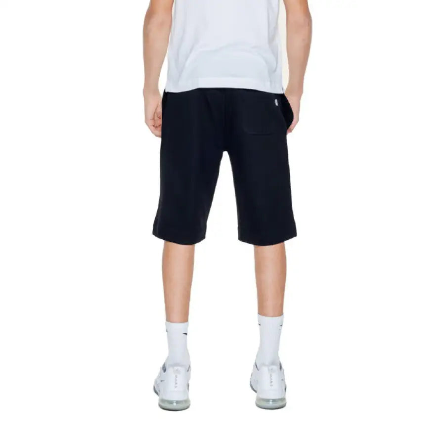Young boy in a white t-shirt and black Moschino Underwear Men Shorts