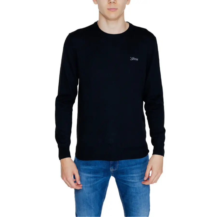 Young man in a black ’person’ sweater from Guess Men Knitwear