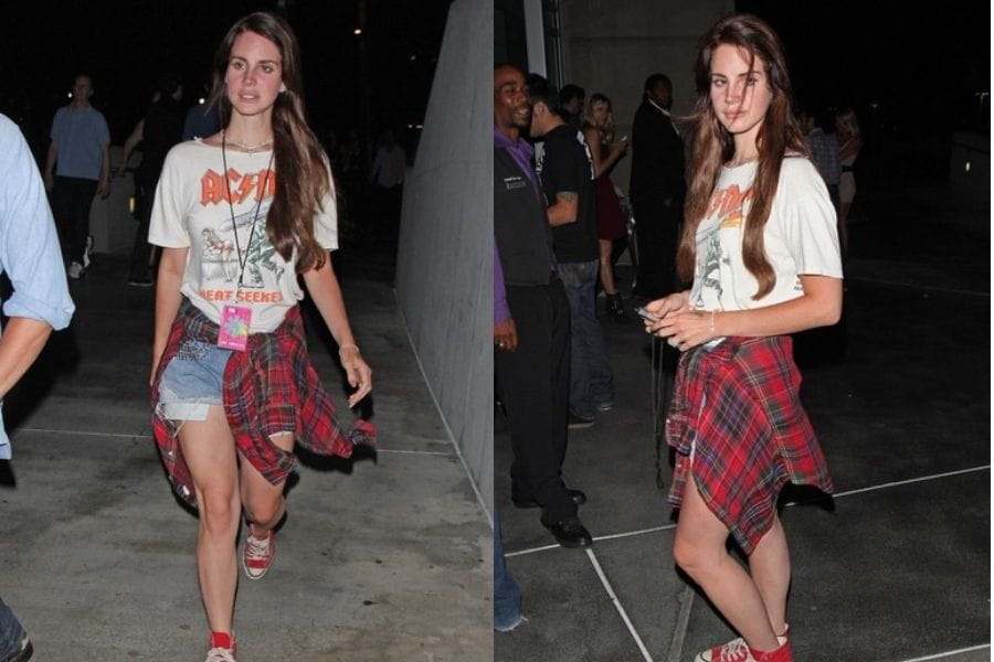 Young woman in a white t-shirt, denim shorts, and plaid shirt, embodying retro style.