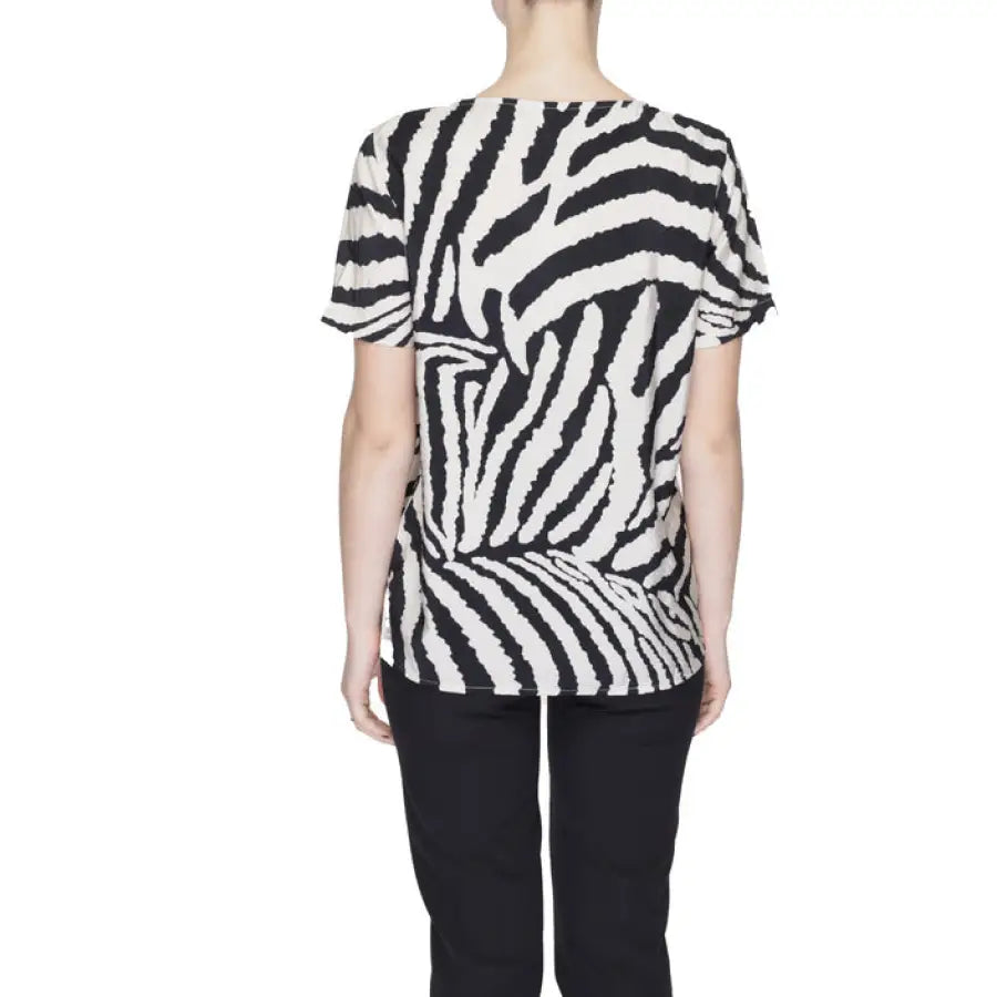 Person wearing zebra-print Jacqueline De Yong short-sleeved shirt viewed from the back