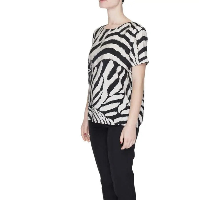 Zebra-print short-sleeved Jacqueline De Yong top paired with stylish black pants for women